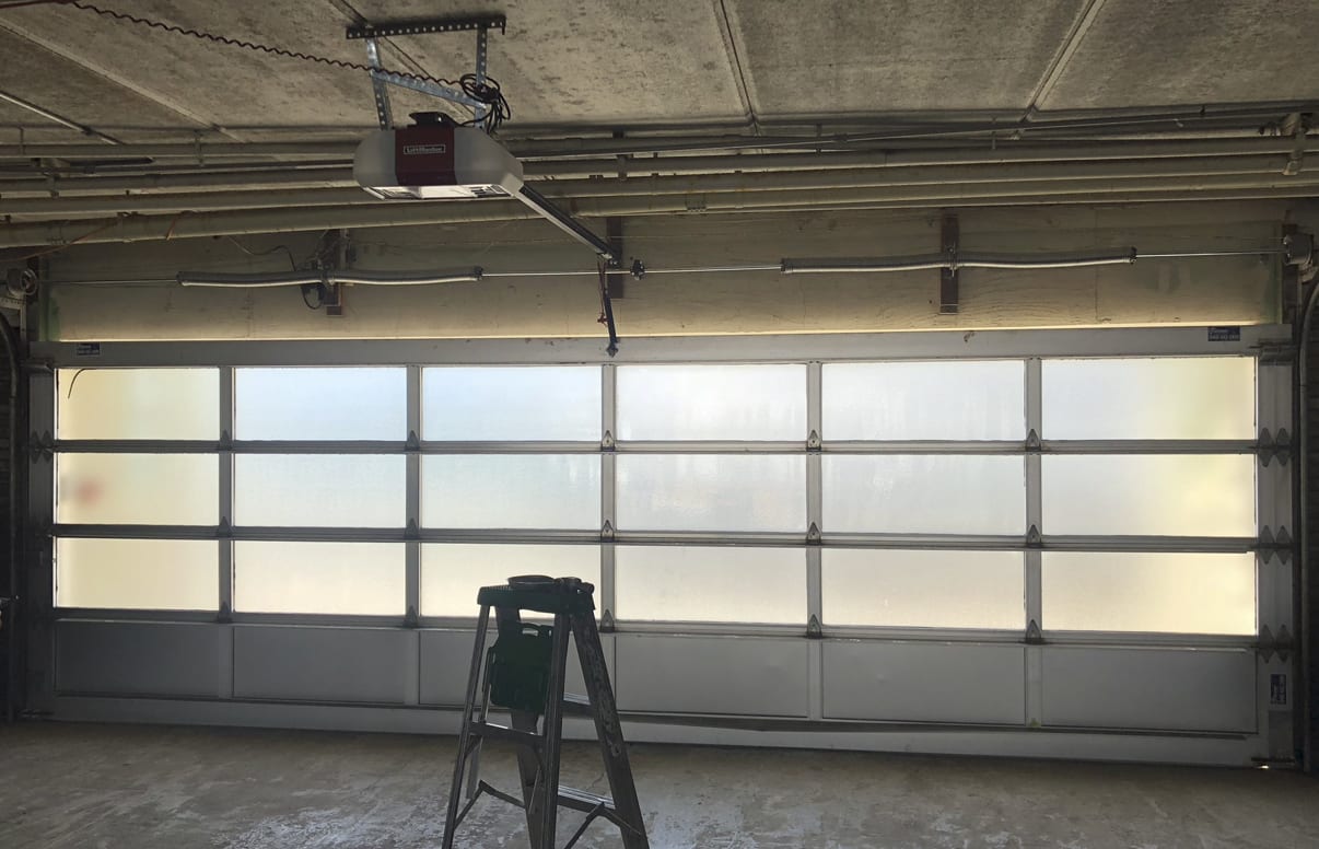 Glass garage door with LiftMaster opener inside a commercial garage