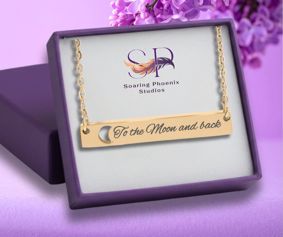gold necklace with "to the moon and back" displayed in a gift box