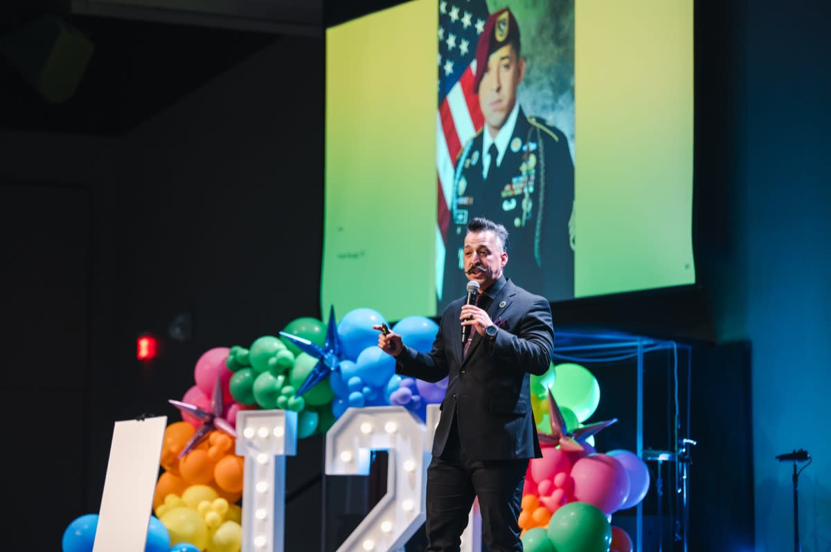 William Garay Jr. speaking on stage at a leadership event