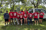 Staff from Palm Beach Atlantic University glean mangoes to support families in need.