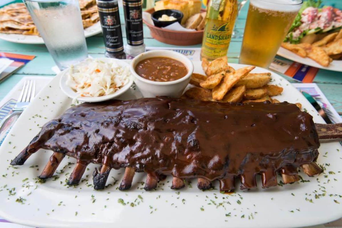 BBQ ribs glazed in dark sauce served with coleslaw, baked beans, and seasoned fries.
