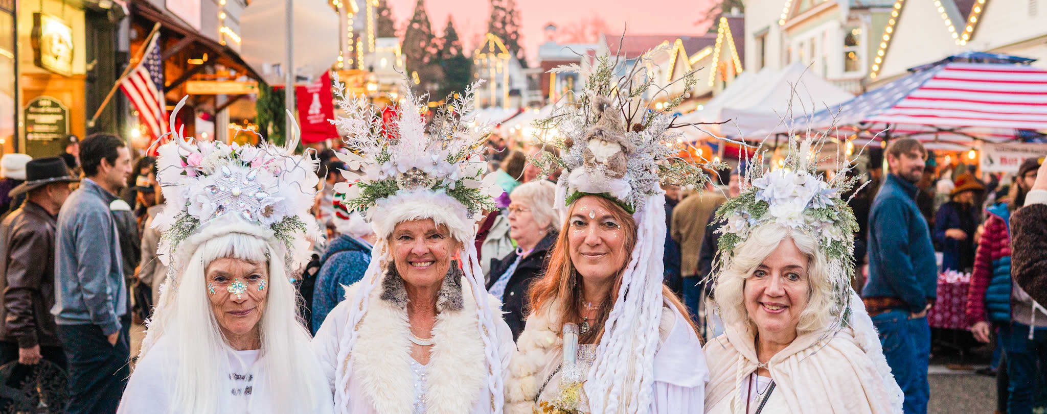 women posing wearing all white with antlers and furs and jewels at Victorian Christmas in Nevada City