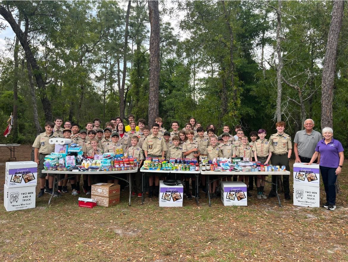 Cub Scouts and volunteers collecting donations for the TWO MEN AND A TRUCK Movers for Moms program