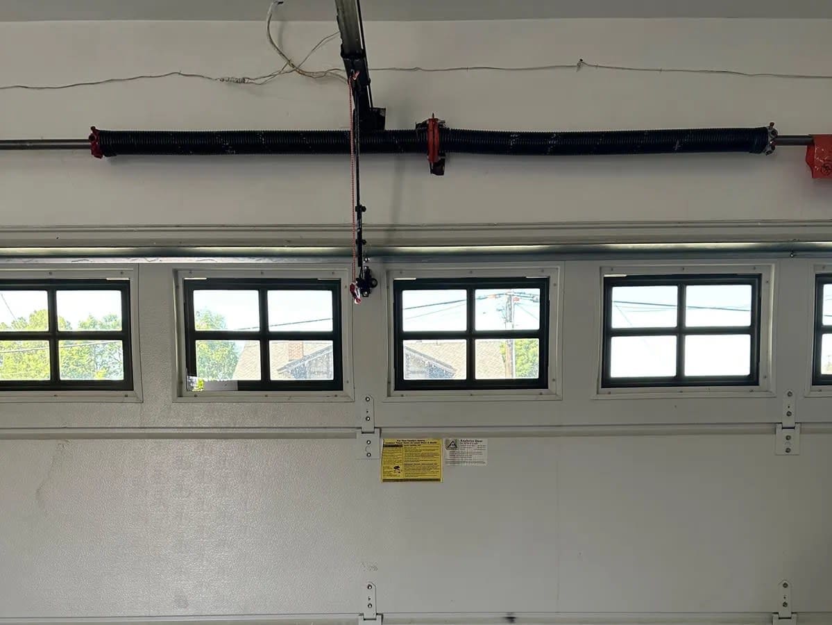 New torsion spring installed above a garage door in North Tustin by Orange County Garage Doors