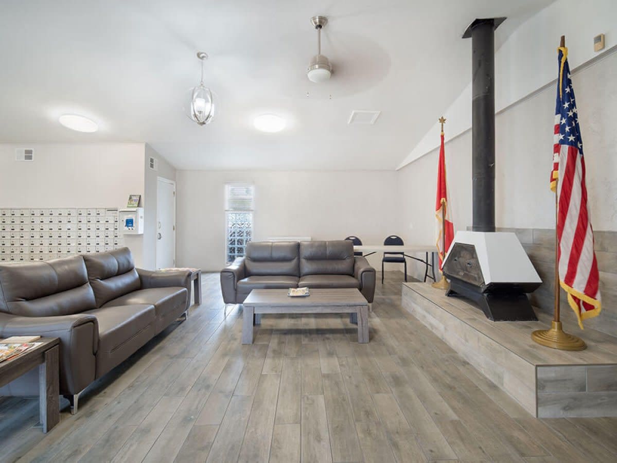 Indoor clubhouse lounge with leather sofas, fireplace and American flag