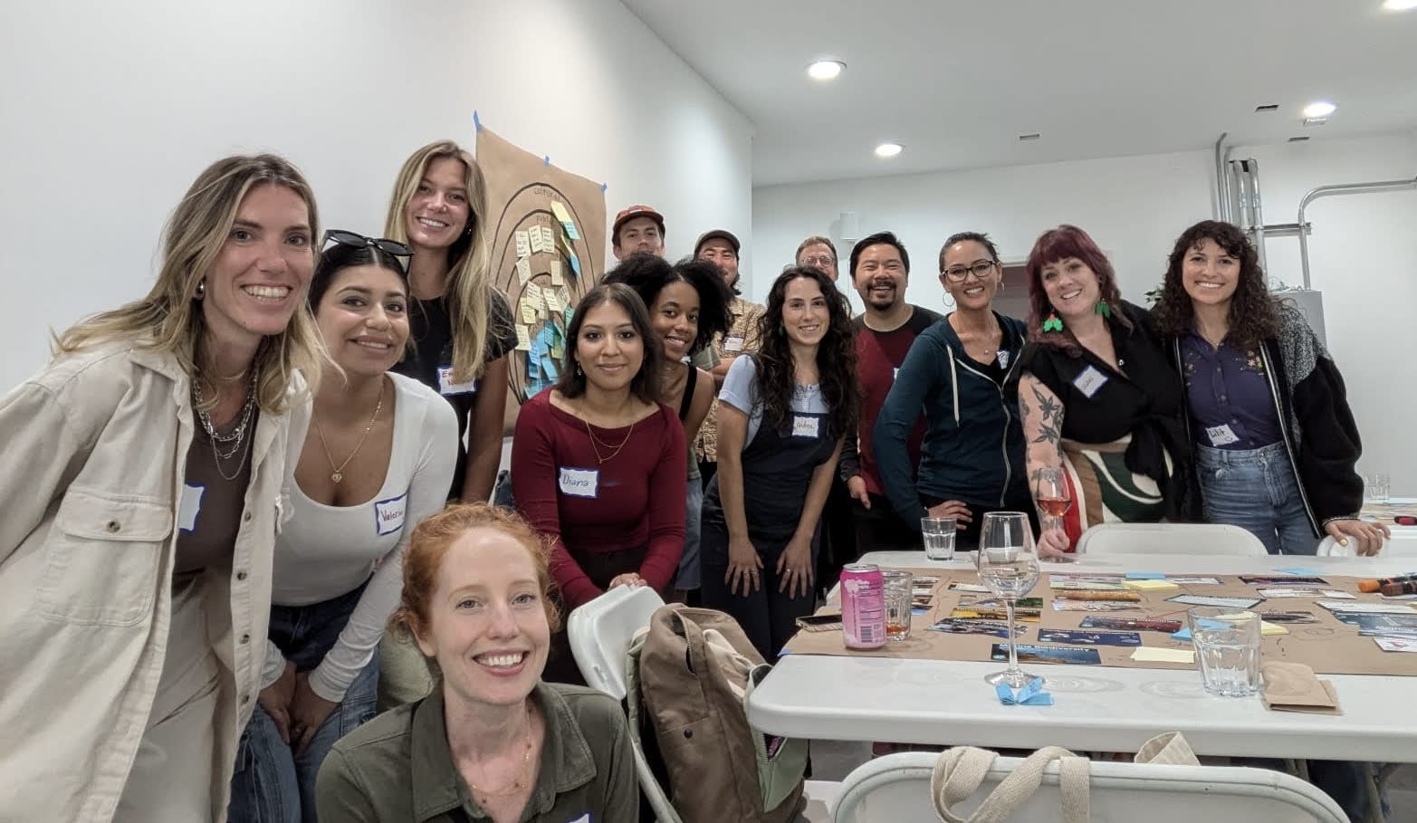 A group of people standing around a workshop table