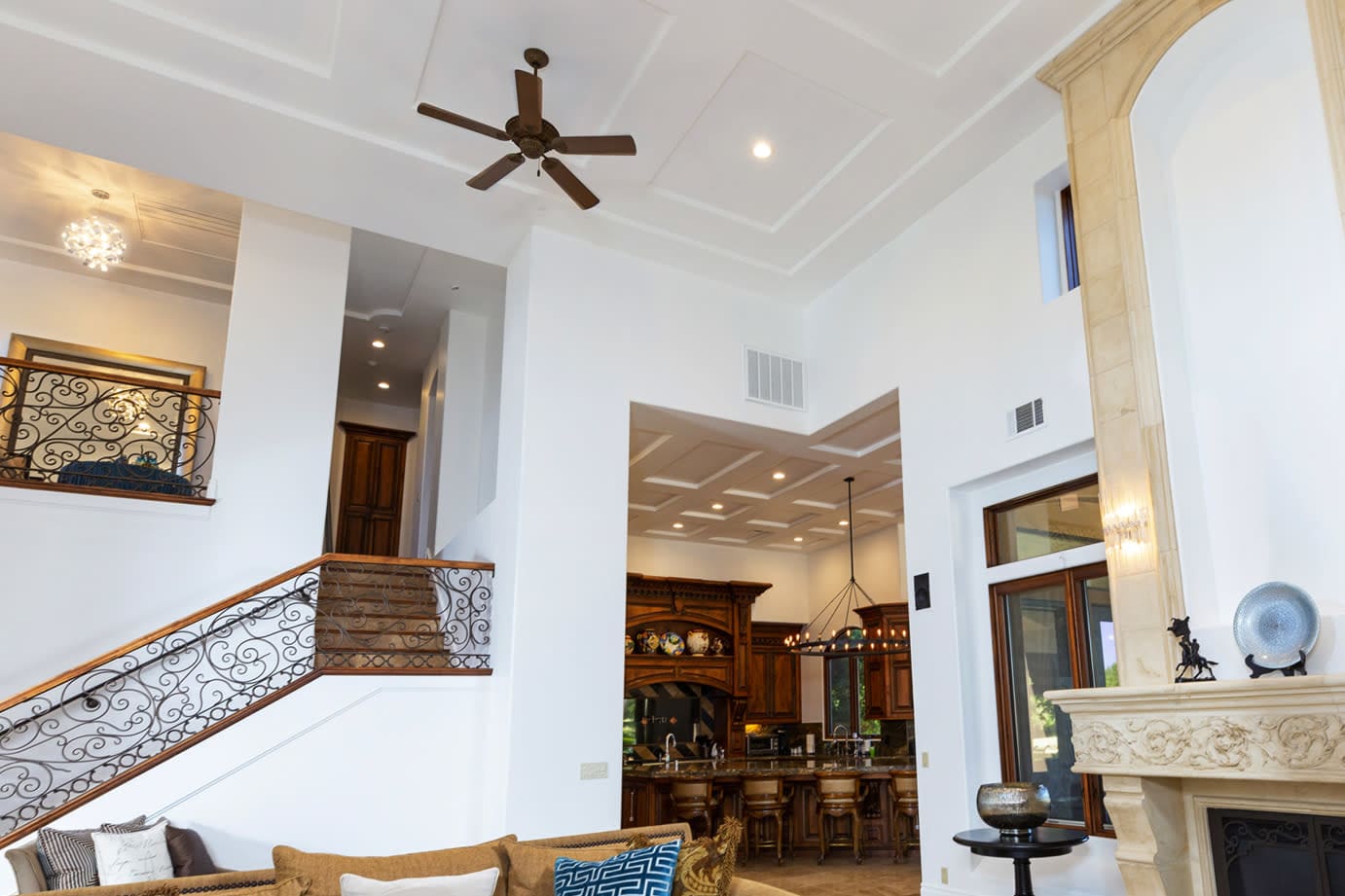 Interior painting in Roseville, CA showcasing high ceilings, detailed crown molding, and custom stair rail by TRICO Painting