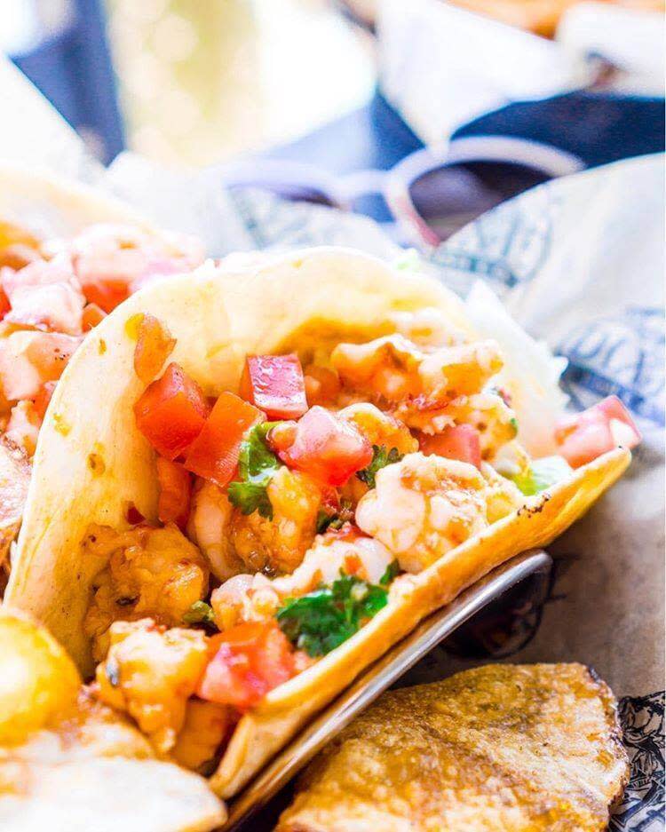 Shrimp tacos with fresh pico de gallo salsa on soft tortillas, served with tortilla chips