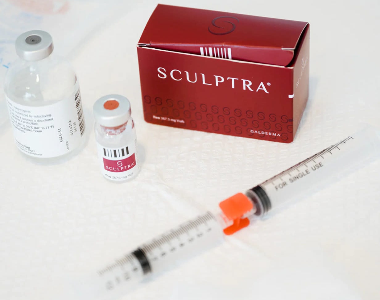 Sculptra collagen biostimulator box, vial, and syringe prepared for aesthetic treatment