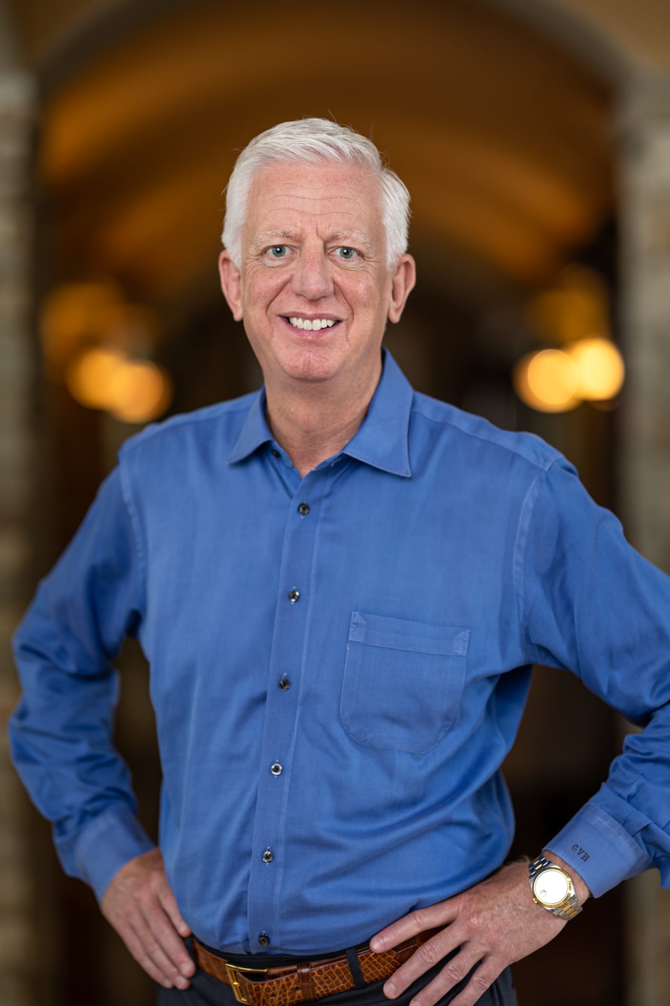 A portrait of Gordon Hartman, smiling and wearing a blue button-down shirt