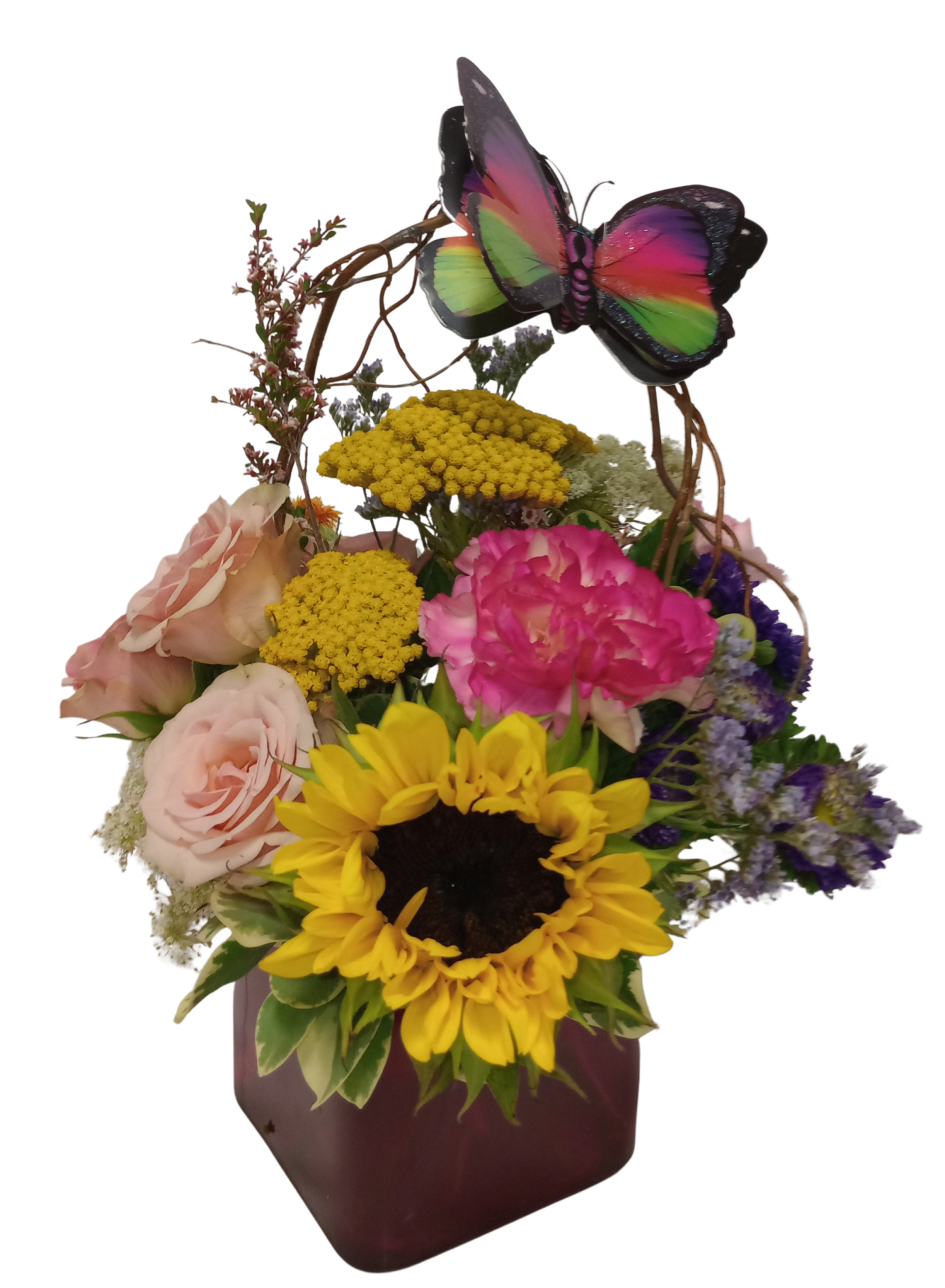 Crescent shaped floral design with large Gerbera daisies as the focal area.  The crescent line is created with wired Equisetum and Bottle brush flowers.  Design is in a cube vase. 