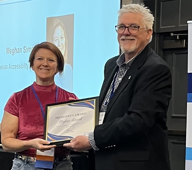 Gene handing a framed award to Meghan