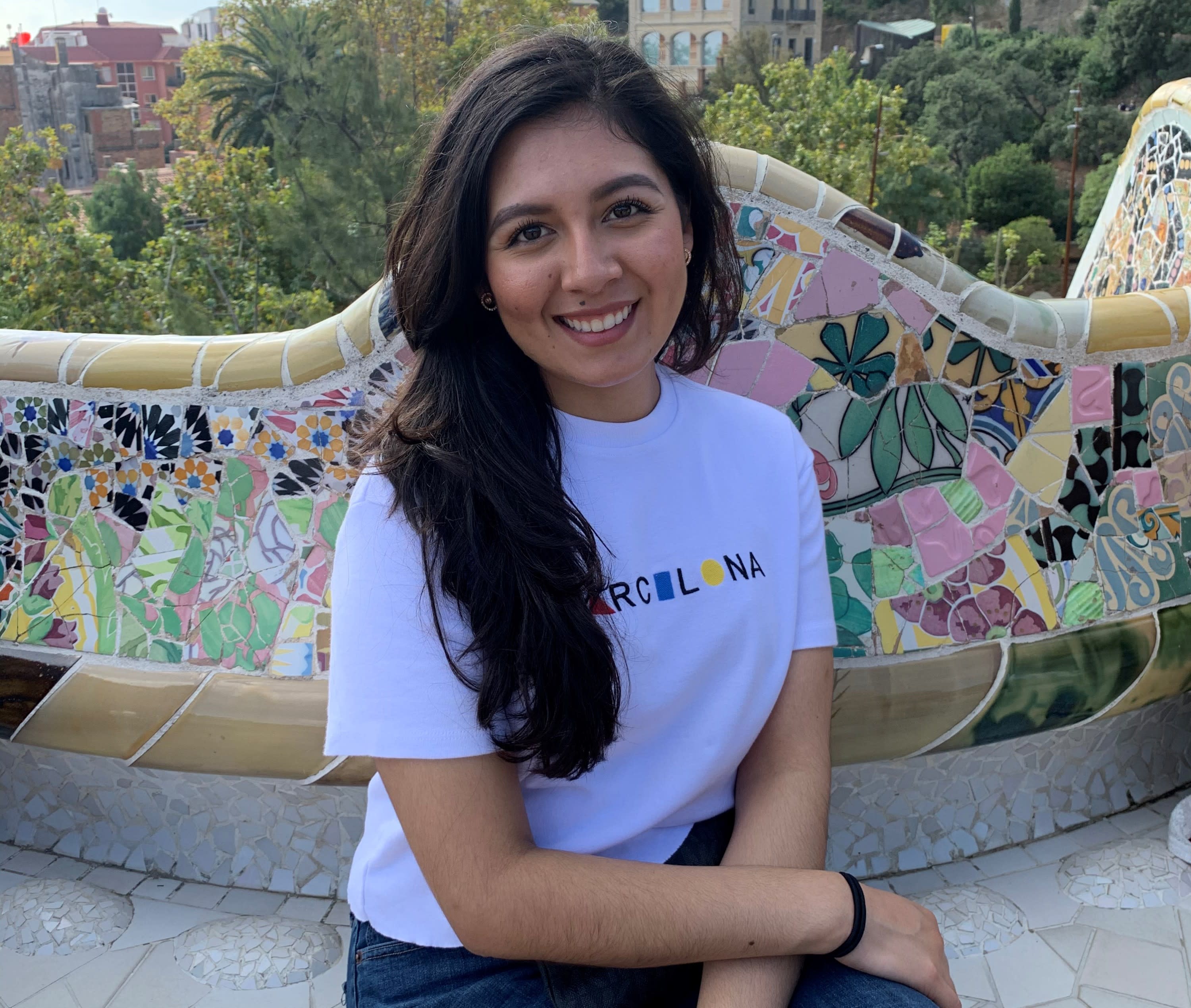 Photo of a young Latina woman with a white shirt and dark hair.