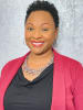 Headshot of an African American woman in a black shirt with a berry-colored blazer and multicolored necklace