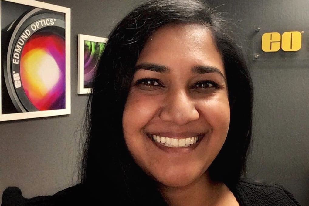 Profile picture with Edmund Optics artwork and logo in the background