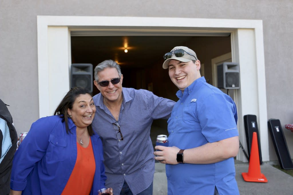 three people smiling for the camera