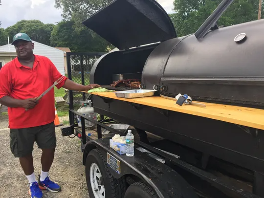 Ron Jones stands next to the smoker at Back Alley Barbecue in Pennsauken.