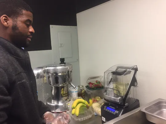 Owner Seth Amoah prepares to make a fresh-pressed juice at The Juice Bar in Merchantville.