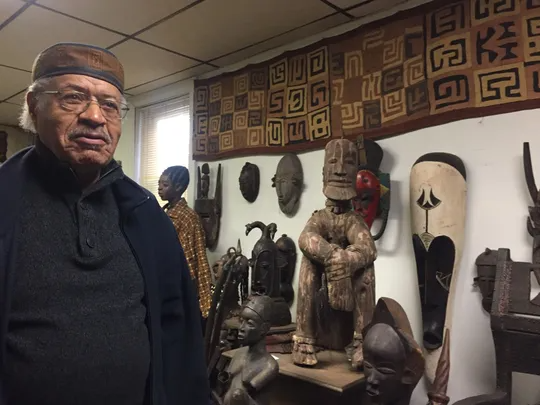 Larry Miles shows some of the African art on display at his Camden bookstore and cultural center.