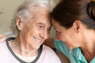 Caregiver supporting senior on walk