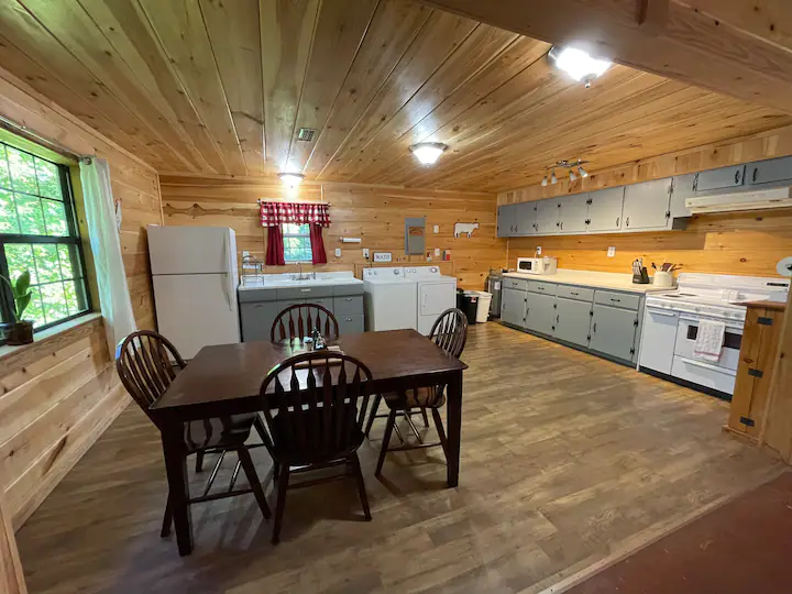 Kitchen with microwave, stove, oven, and keurig with coffee pods. 