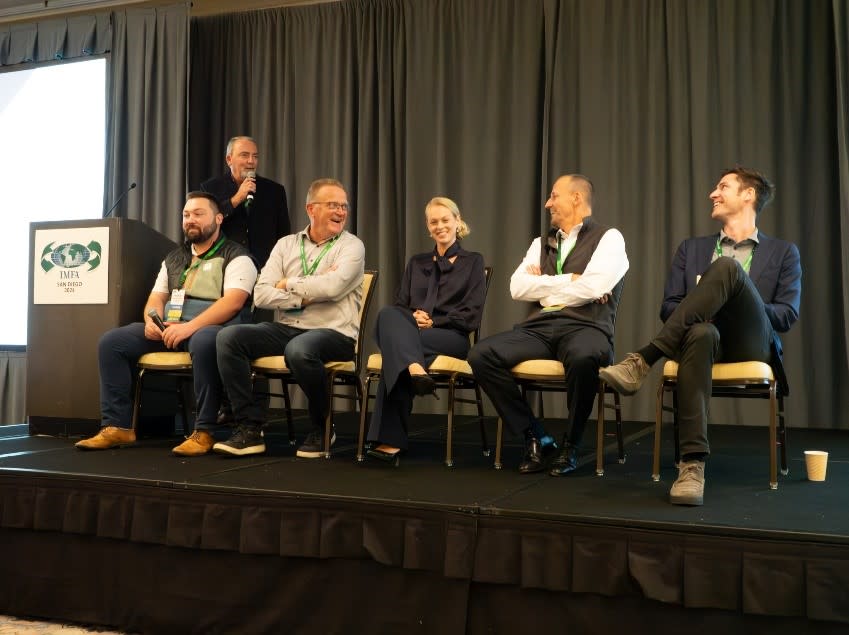 A group of people sitting on a stage 
Description automatically generated