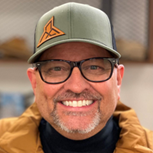 A person wearing glasses and a hat

Description automatically generated