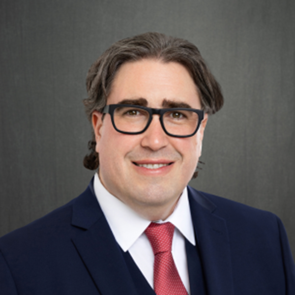 A person in a suit and tie

Description automatically generated