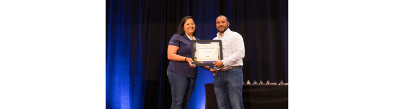 A person and person holding a framed award

AI-generated content may be incorrect.