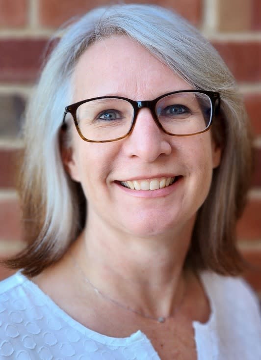 A person wearing glasses smiling 
AI-generated content may be incorrect.