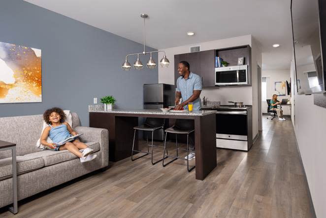 A person and child sitting on a couch in a living room

AI-generated content may be incorrect.