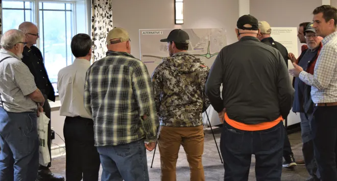 A group of visitors looks over the fifth alternative for the U.S. Route 62/state Route 39, state Route 557 and County Road 201 intersections safety improvement project during a meeting in Charm. Three of the five alternatives presented involve roundabouts.