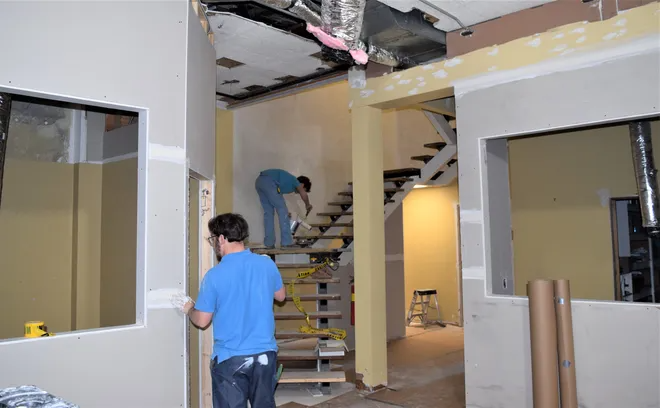 Employees of Bryan Dry Wall work on the new offices at the Holmes County Chamber of Commerce. The doors to a visitors center will be open evenings and weekends, unstaffed, so visitors to Millersburg and Holmes County have access to informational brochures and a restroom.
