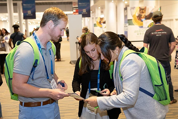 Group of attendees at an educational conference gather between sessions