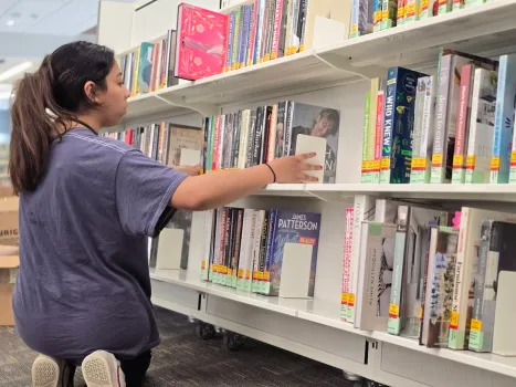 Now that a $4 million expansion and renovation project is now complete at the South Elgin branch of the Gail Borden Public Library, employee Isabella Aguinaga adds books to the shelves in preparation for the grand reopening on Saturday, June 21, 2025. (Gail Borden Public Library District)