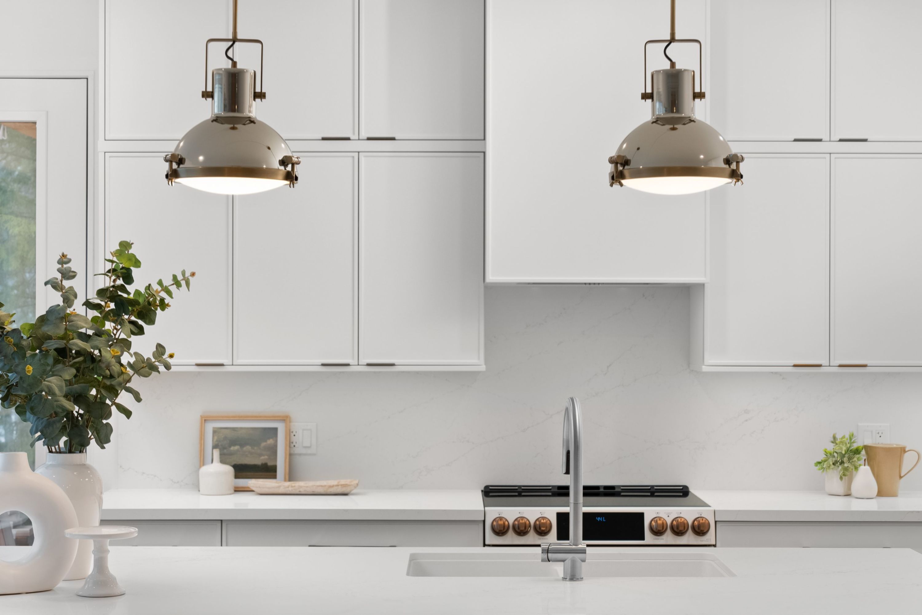 A kitchen with white cabinets and light fixtures

AI-generated content may be incorrect.