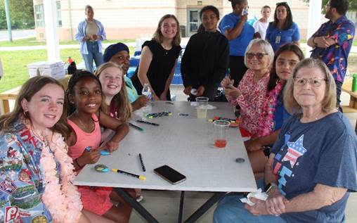 A group of people sitting around a table

AI-generated content may be incorrect.