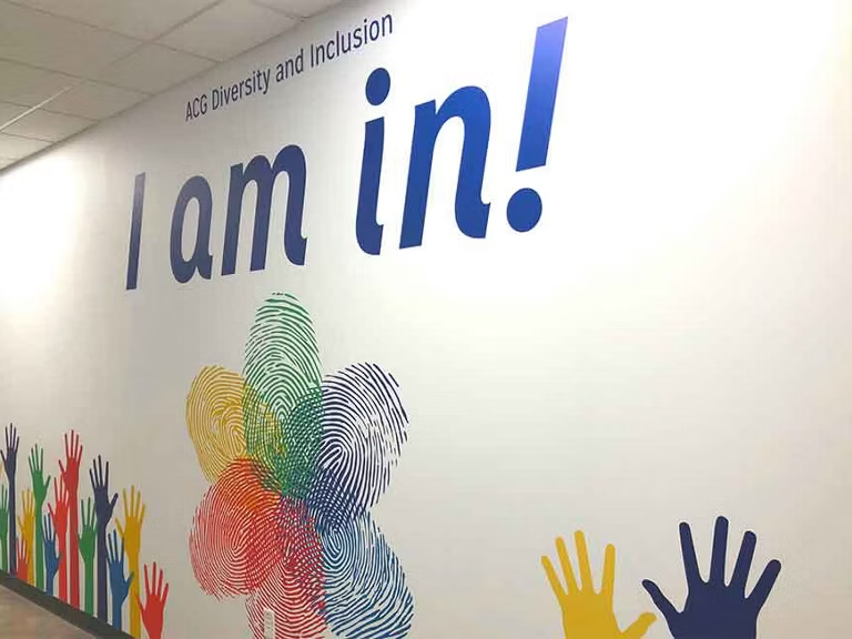 acg diversity and inclusion wall mural saying i am in with hands reaching towards the sky