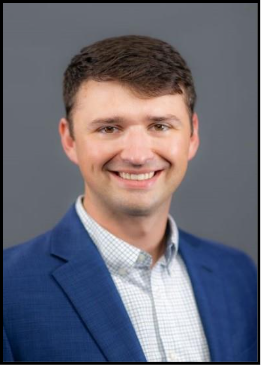 A person smiling for the camera 
Description automatically generated with medium confidence
