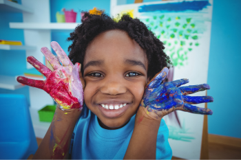 Messy Art Child with finger paint on hands