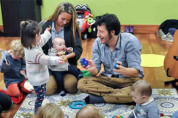 photo of adult teaching music to children