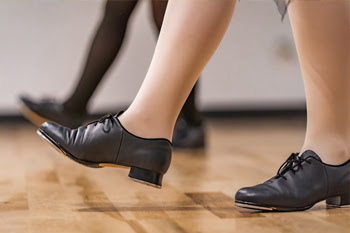 feet wearing tap dancing shoes