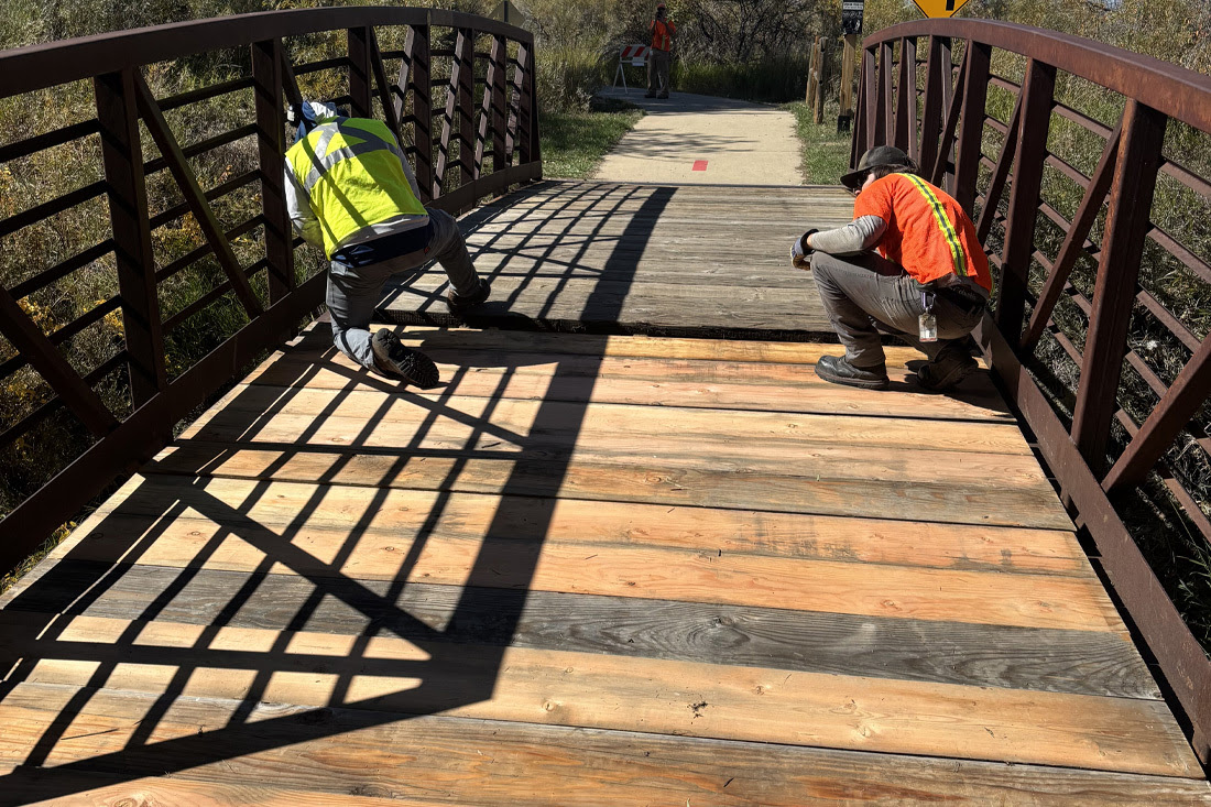 crew replacing planks on a bridge
