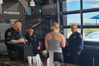 Photo of Louisville police officers and residents at Coffee with a Cop event