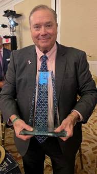 A person holding a glass award

AI-generated content may be incorrect.