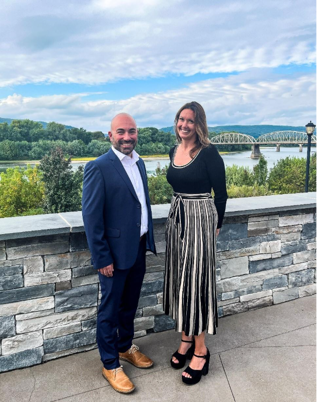 A person and person standing next to each other 
AI-generated content may be incorrect.