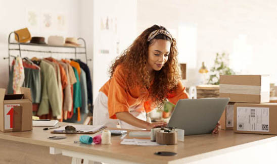 Female small business owner working back office to fulfill orders