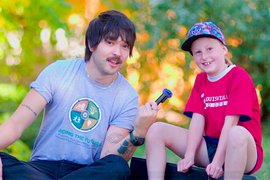A person interviewing a kid for the PROS Guidebook 