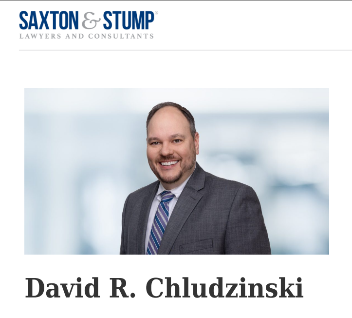 A person in a suit smiling 
AI-generated content may be incorrect.