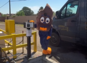 swirly mascot posing at the rv dump station kiosk
